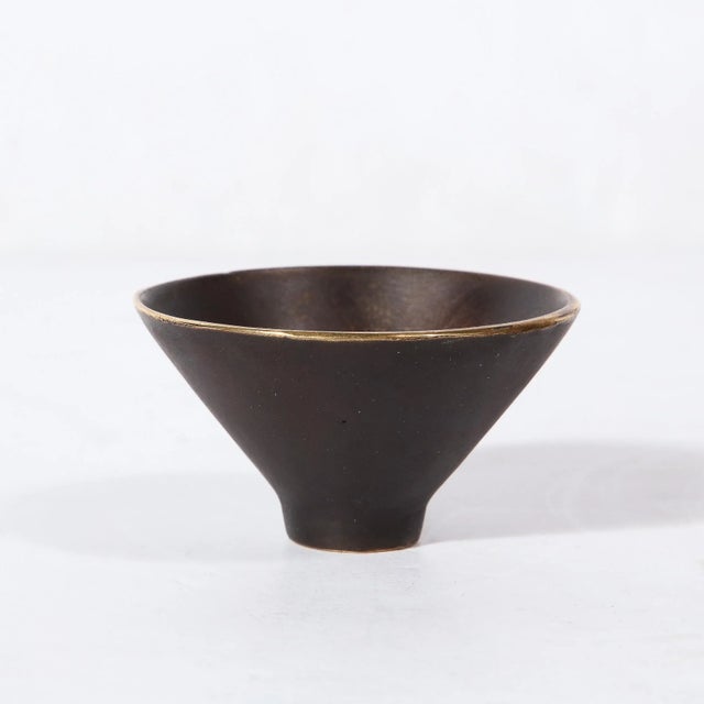 This stunning and minimal Mid-Century Modernist patinated Brass Conical Dish was made by the esteemed artist Carl Aubock...