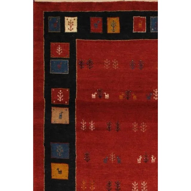 Persian Gabbeh Hand-Knotted Rust Area Rug is handmade with extra high pile and very simple, stylized designs. They are...