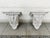 Pair of antique decorative wood brackets, hand-painted white. Carved acanthus leaves decorate the front crest, while a...
