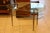 This very nice mid century glass top side table or coffee table features a free style shape and rests on 3 brass legs. It...