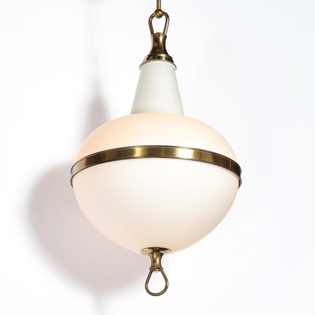 This elegant Mid-Century Modern Murano Glass & Brass Pendant Chandelier originated in Italy, circa 1960. The fixture...