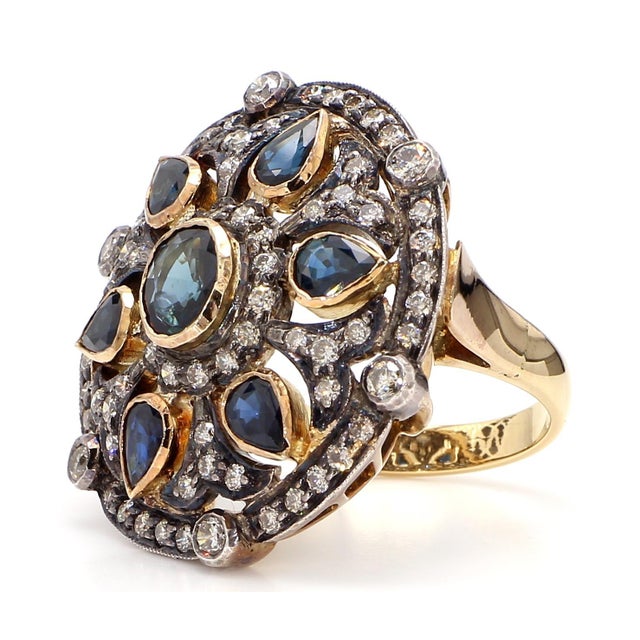 The Antique Round Blue Sapphire Ring is a stunning piece of jewelry that exudes timeless elegance and sophistication....