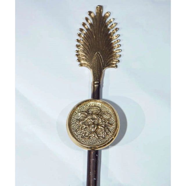 Pair of Neoclassical 2-light wall sconces, circa 1940s. Made of metal and bronze. Shaped as an arrow decorated with two arms.