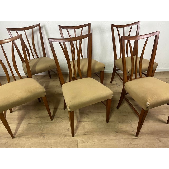 Set of 6 light wood chairs with original beige fabric seats, featuring curved lines clearly attributable to the design by...