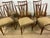 Set of 6 light wood chairs with original beige fabric seats, featuring curved lines clearly attributable to the design by...