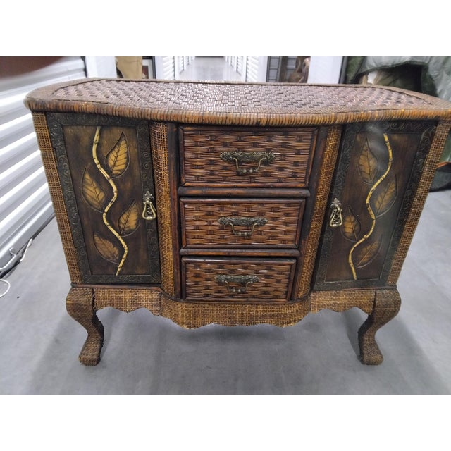 Mid to late 20th century Woven Rattan & Wicker Solid wood frame Hand rubbed finish Hand painted gold tone leaf Overall...