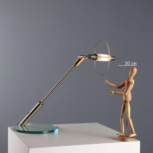 Table lamp with glass base, satin metal stem. This piece is attributed to the mentioned designer/maker. It has no...