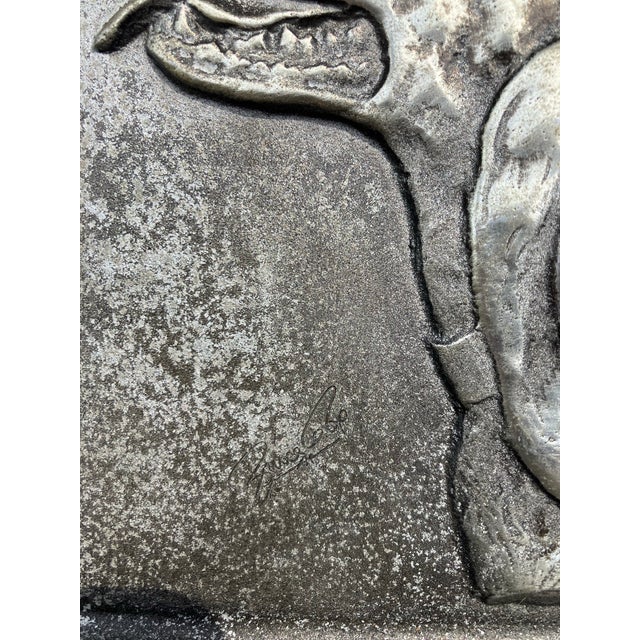 A pair of approximately 5.5 wide by 7 high by 3 deep heavy steel bookends Both signed & felt backed