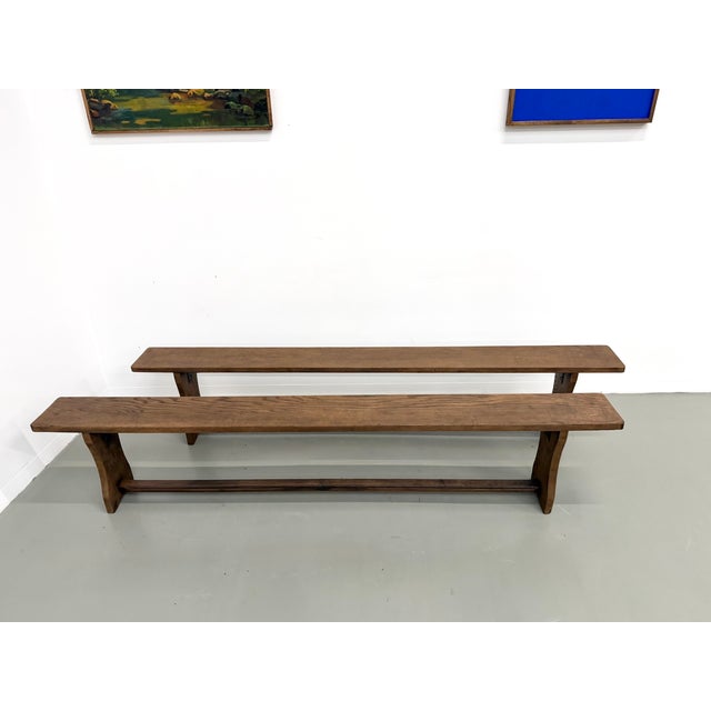 Pair of solid oak benches, made in france in the 1970s. The long, narrow top, with its pronounced grain, rests on two...
