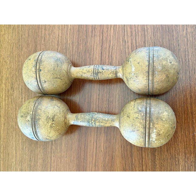 A charming pair of antique turn-of-the-century wooden dumbbells (hand weights), perfect for adding vintage warmth to...
