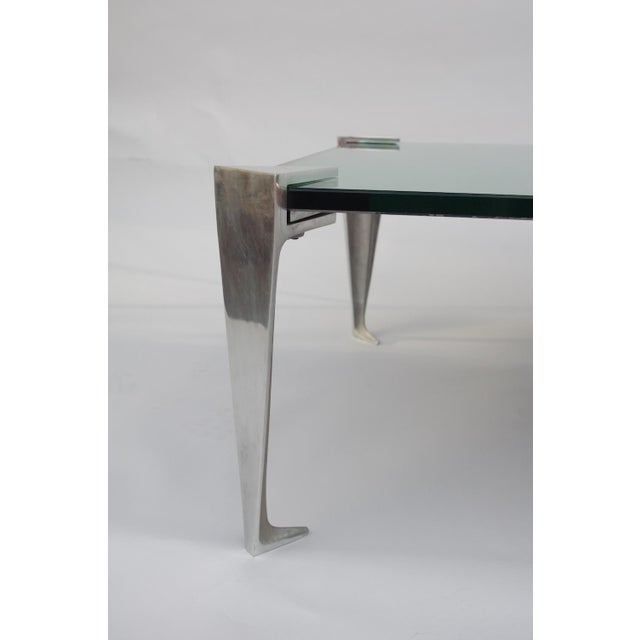 Coffee table with canted corners mirrors top resting on four aluminum legs. Minor losses in the mirror. Work from the 1980s.