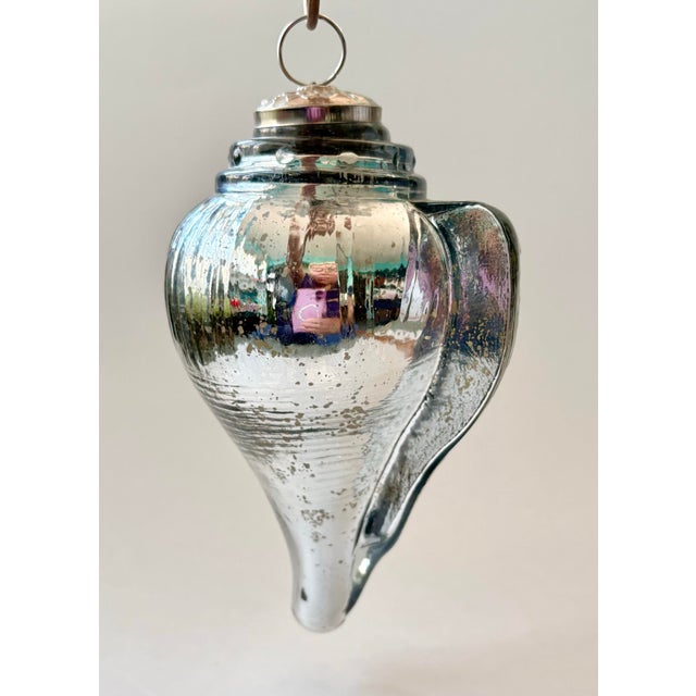 An exceptional oversized vintage mercury glass Christmas ornament crafted in the form of a realistic conch shell or sea...