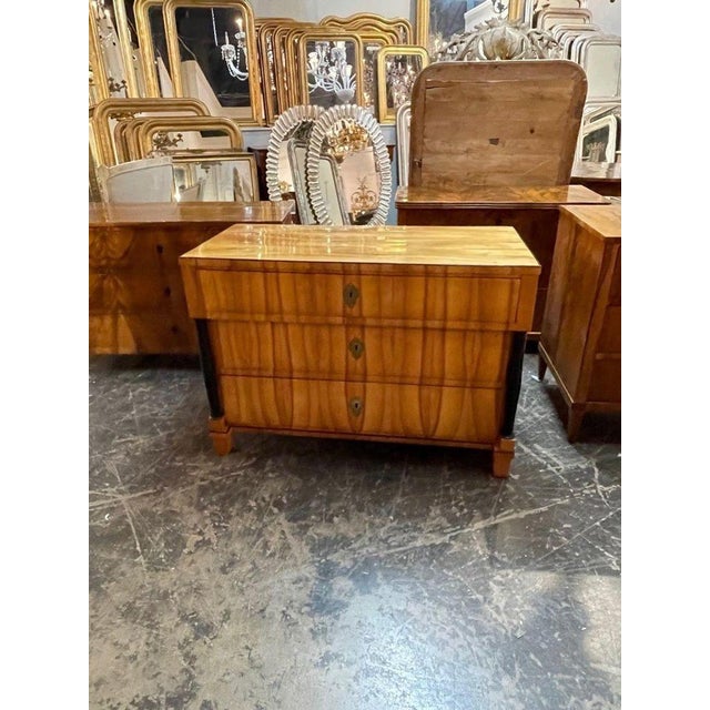 Handsome period German Biedermeier blond walnut and ebony commode. Beautiful polished finish and gorgeous wood grain....