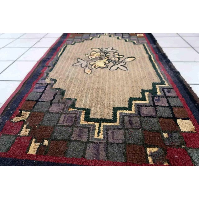 Handmade antique American Hooked rug in floral design. The rug is from the end of 19th century in good condition, the rug...