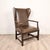 A bespoke wing chair Dover by Gregorius Pineo with olive green leather and hardware frame, circa 1980. Seat height 19".