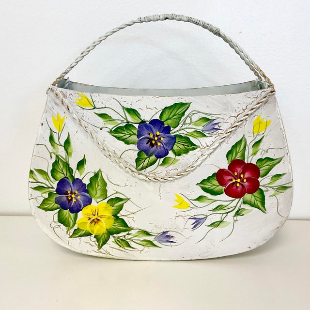 This is so pretty. A metal hand painted tole basket to hang on a wall. The artist painted colorful pansies and leaf...