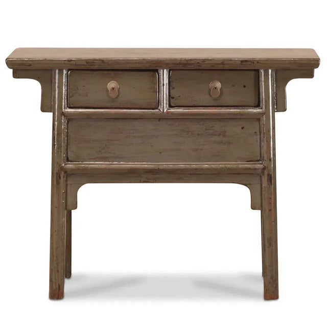 Crafted in the Shandong province circa 1920, this slender side table boasts a lustrous lacquered finish and tapered legs....