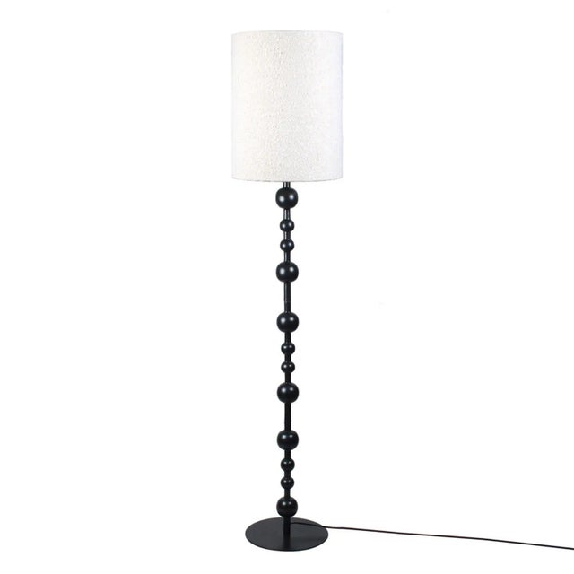 Modern floor lamp with black finish aluminum / iron tall base featuring fun ball pattern all the way up. Soft white boucle...