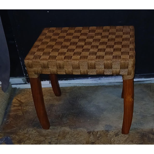 Boho chic rattan basket weave footstool or ottoman. Made approximately in the 90s. Acacia wood frame and tapered legs....