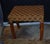 Boho chic rattan basket weave footstool or ottoman. Made approximately in the 90s. Acacia wood frame and tapered legs....