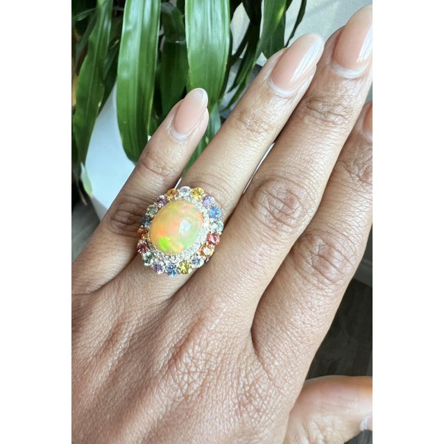 6.52 Carat Opal Rainbow Sapphire Yellow Gold Statement Ring This stunning statement ring features a 6.52-carat cabochon-...
