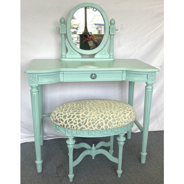Precious vintage French style vanity with coordinating stool from the late 20th century. They have fluted legs and an oval...