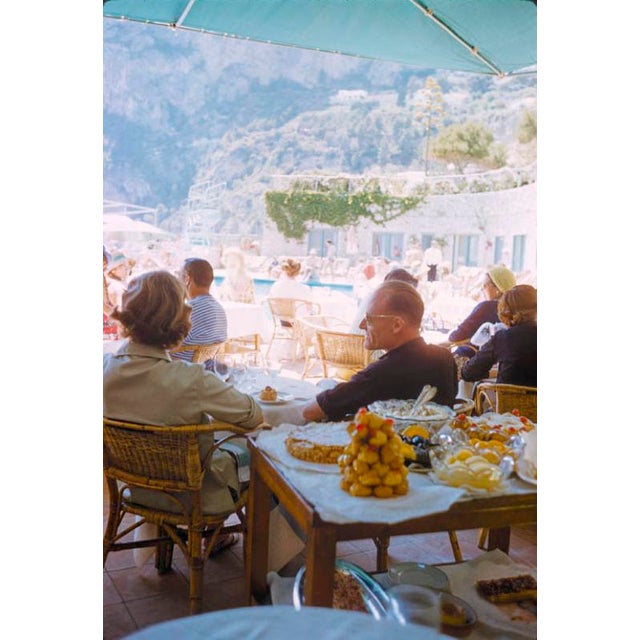 A Beachside Meal In Capri 1959 Holidaymakers enjoy a meal at a beachside restaurant in Capri, Italy, 1959. Toni Frissell...