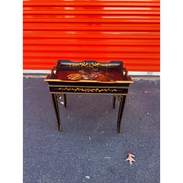 This beautiful hand-painted tray table features a removable floral tray with cut-out handles and elegant gold chinoiserie...