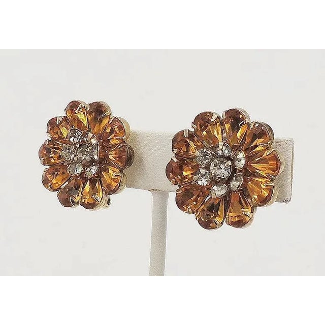 1950s goldtone faux-topaz and clear rhinestones flower clip back earrings. Marked "Kramer of NY." Measure: 1 inch across....
