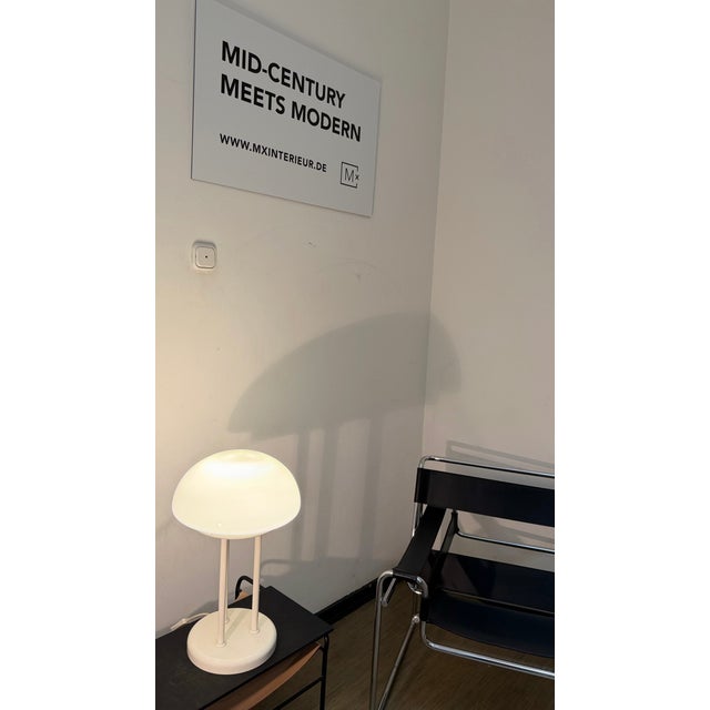 A beautiful designer table lamp (1970s) that adds a touch of mid-century modern style to any home. The hemispherical...