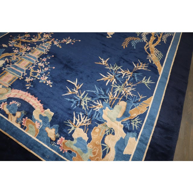 a 1940s Chinese Blue and Ivory rug with a landscape design