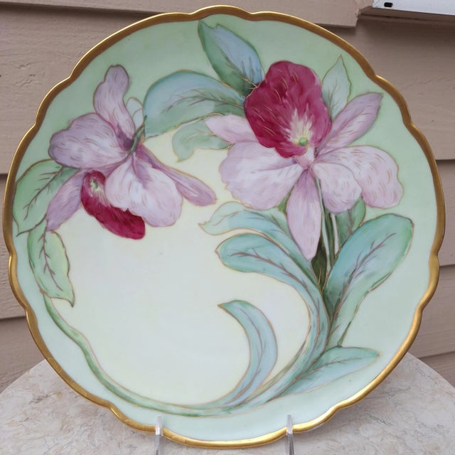 Presenting an artfully executed hand-painted decorative plate for the Art Nouveau interior. Featuring curved orchid...