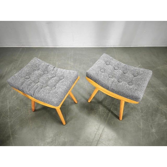 A refined pair of mid century stools produced in czechoslovakia during the 1960s. Crafted from solid maple wood, the...