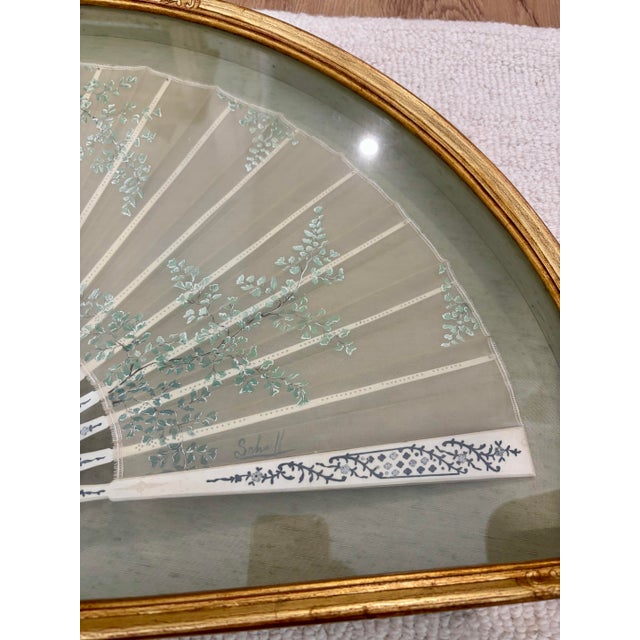 An elegant antique hand-painted ladies fan, 19th century, beautifully preserved and professionally framed in a gilt half...