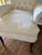 Pair of white cotton upholstered roll arm side chairs. Tufted button backs and down filled cushions. Some spots shown in...