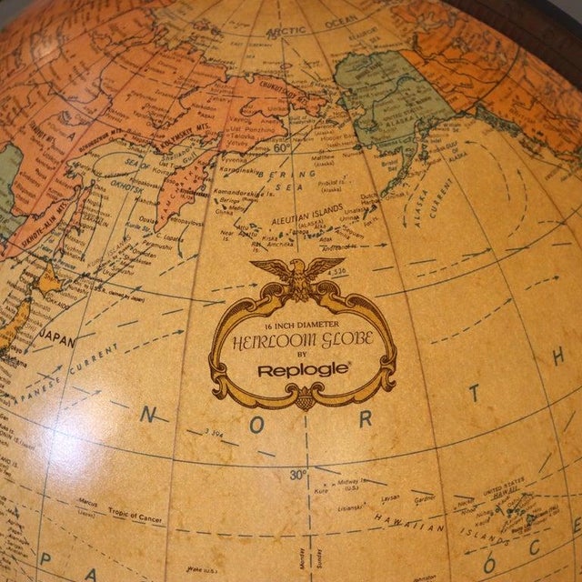 A Mid-Century Modern Replogle Heirloom World Globe, featuring a 16-inch diameter illuminated sphere mounted on a...