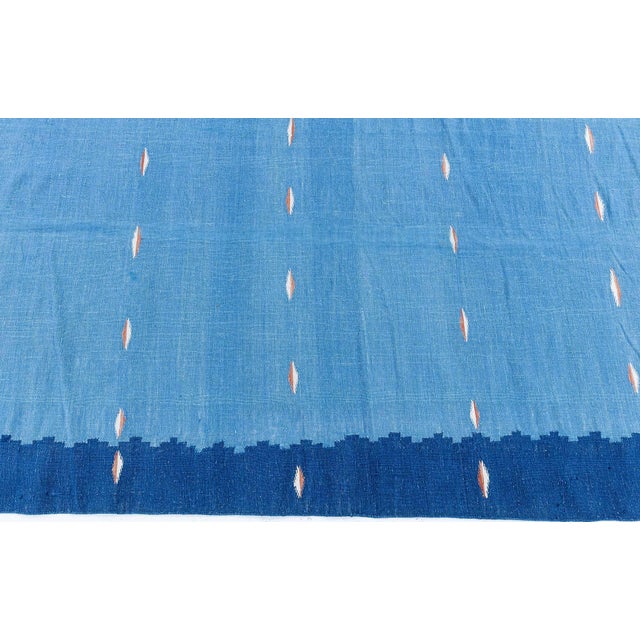 This vintage 1950s Indian Dhurrie rug is a refined expression of mid-century design, combining rhythmic patterning with a...