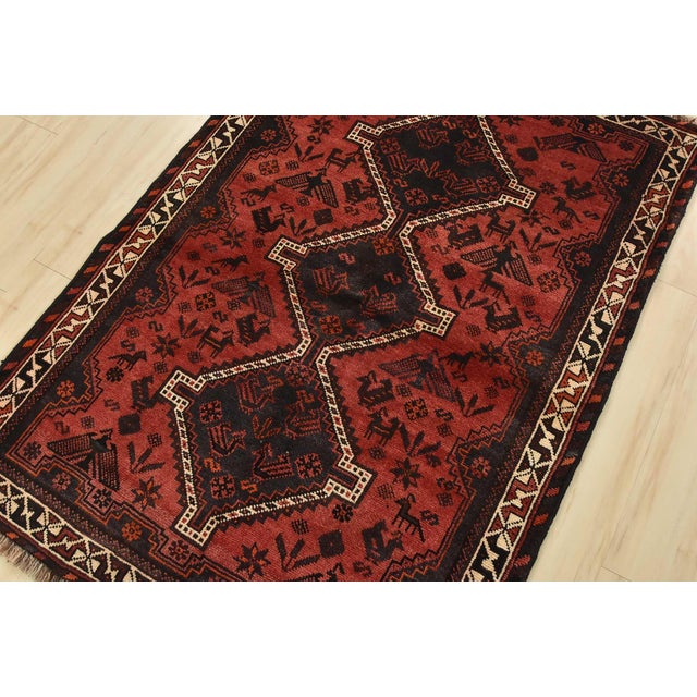 An authentic vintage tribal Shiraz rug hand-knotted with fine wool and natural dyes. This nomadic rug features geometric...