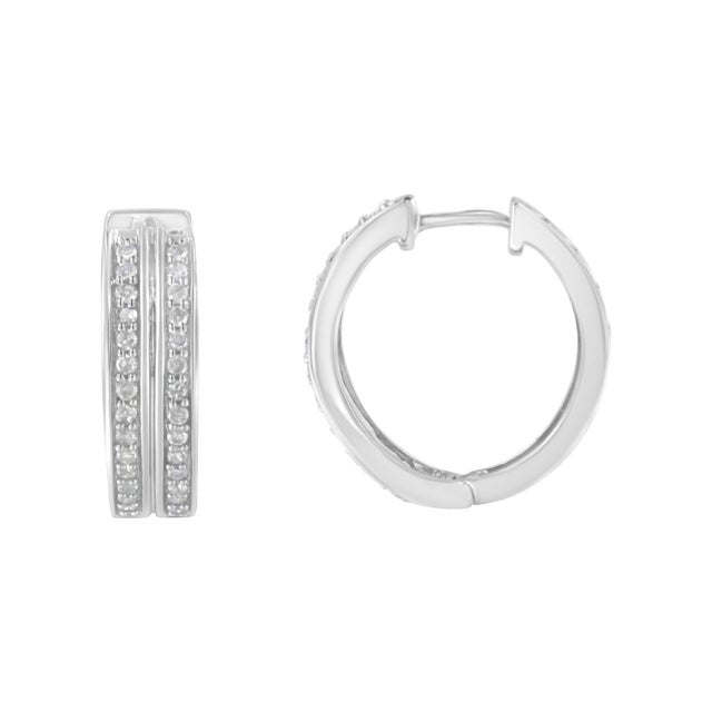 Exuberant hoop earrings made with 10k white gold and genuine diamonds. The round format of the earring contains 56...