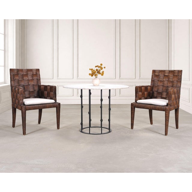 A stunning and rare set of four "Block Island" cane rush wicker dining chairs designed by John Hutton for Donghia in the...