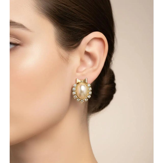 These vintage 1980s Italian clip-on earrings are a quintessential example of decadent late-century glamour, featuring a...