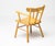 Beautiful, organic and natural armchair in solid honey colored birch. A simplistic design with a round seating and...