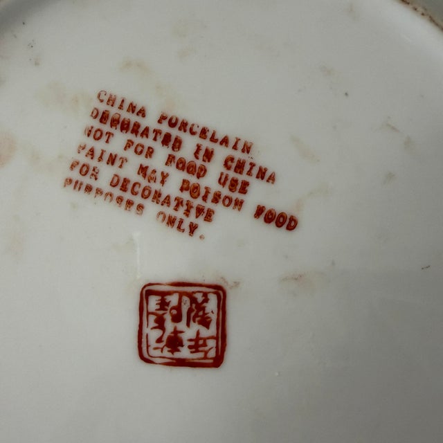 Vintage chinoiserie decorative plate. White background featuring colors of green, pinks and dark reds. Measures 10.25” in...