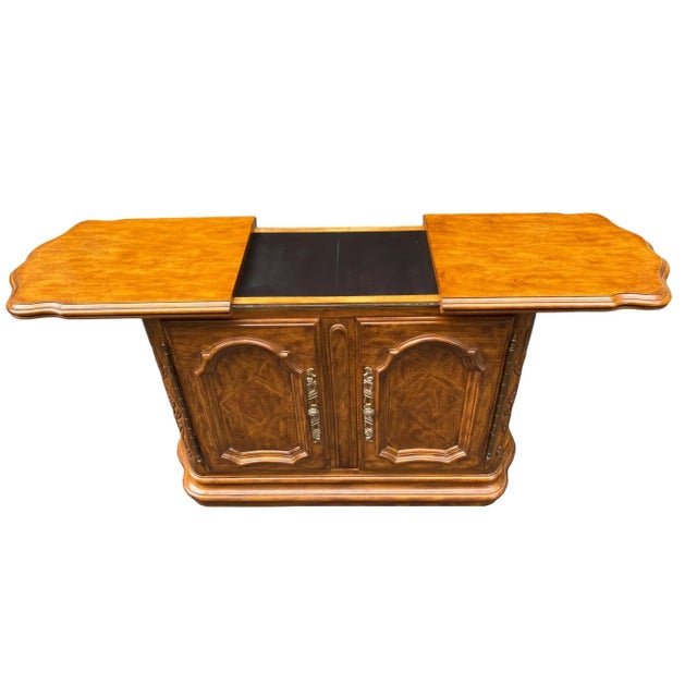 Quick Hits: - Drexel buffet server on wheels - Rich wood finish with intricate carvings and brass hardware - Perfect for...