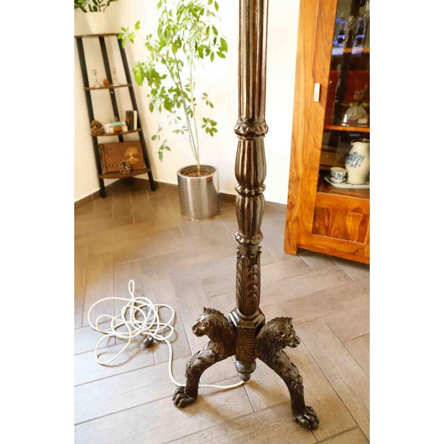 Antique floor lamp from the early 20th century featuring a striking lion motif on its decorative base. The lamp’s...