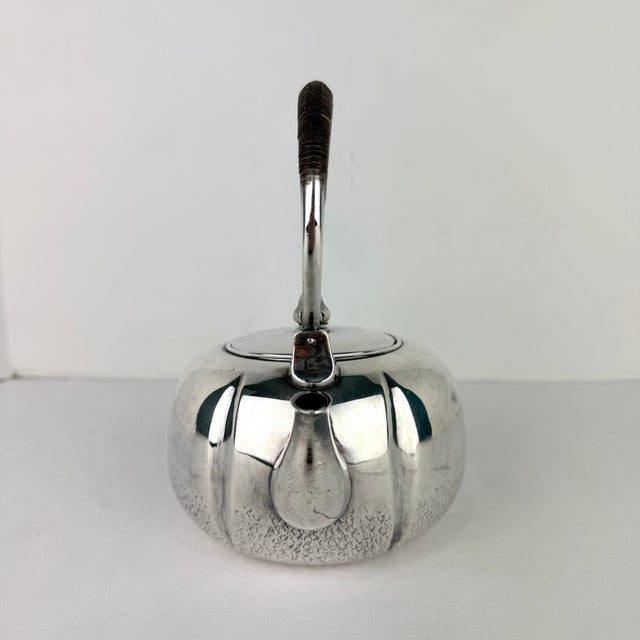 Beautiful vintage Chinese pure‑silver Republic era teapot. The teapot has a hand‑hammered base and a smooth body with...
