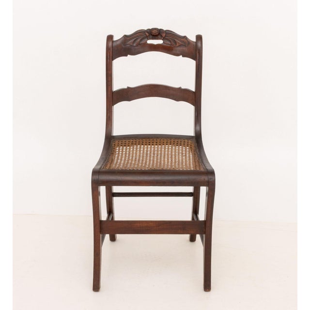 Victorian Mahogany Side Chair, carved floral crest and caned seat on four down swept legs conjoined by box stretcher. 33"...