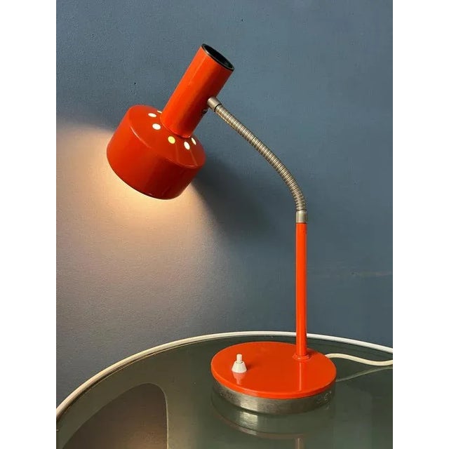 Hustadt leuchten pace age desk lamp in red / orange colour with flexible arm. The arm can be adjusted and also the shade...