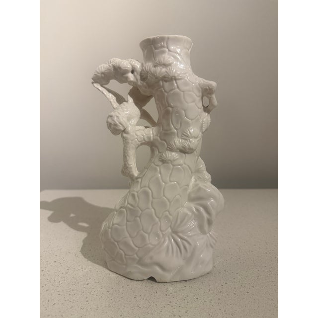 Sculptural vintage white porcelain vase featuring an elaborate three-dimensional design of cranes or herons surrounded by...