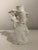 Sculptural vintage white porcelain vase featuring an elaborate three-dimensional design of cranes or herons surrounded by...